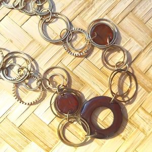 Long antique gold tone necklace with brown accents circle link design